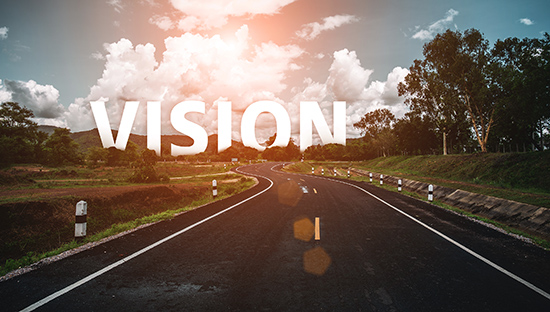 The word vision behind the tree of empty asphalt road at golden